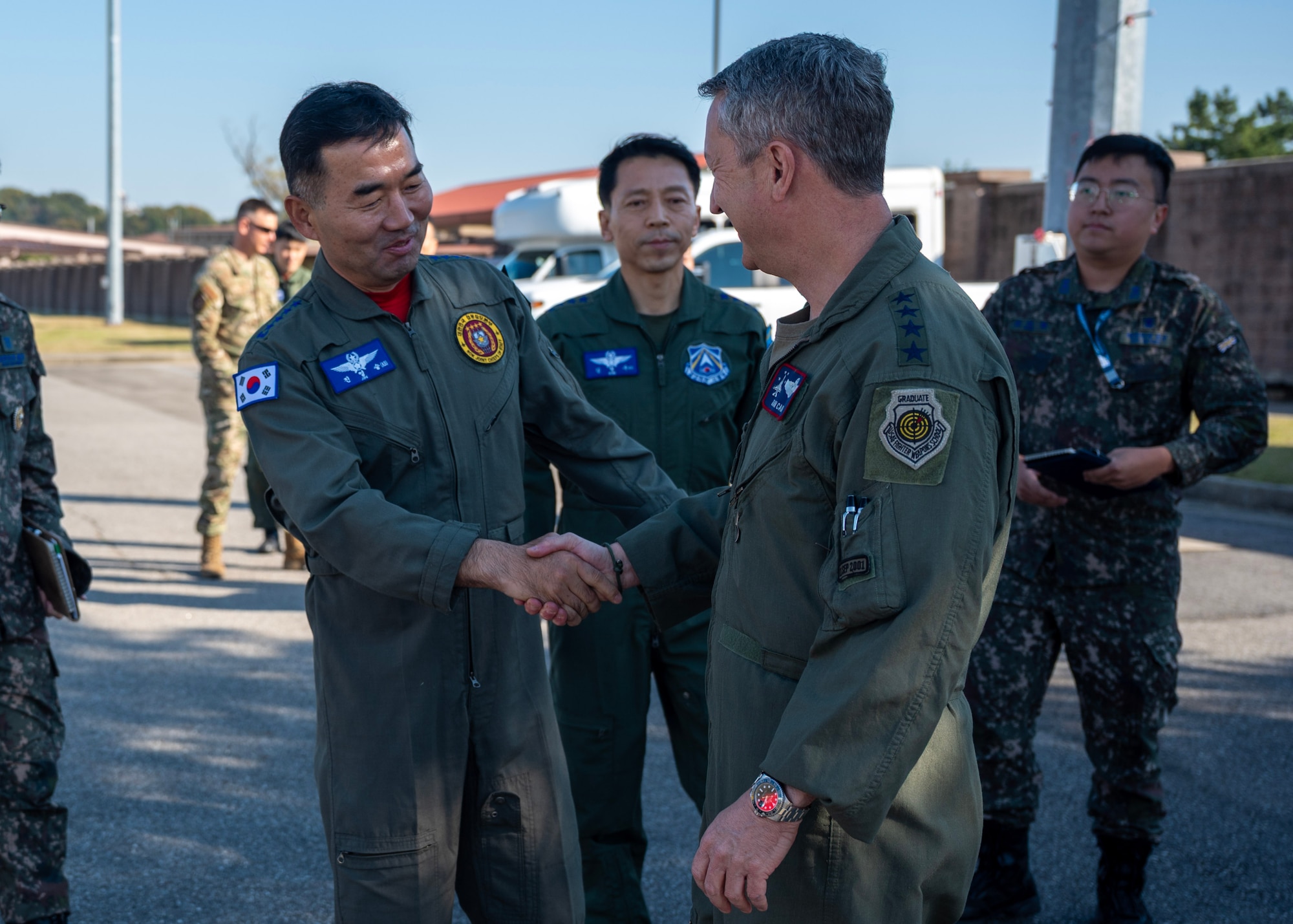 Chairman of the Joint Chiefs of Staff Gen. Dan Caine greets the Republic of Korea Chairman of the Joint Chiefs of Staff Gen. Jin Yong Sung before the U.S.-ROK Combined Command Flight at Osan Air Base, ROK, Nov. 3, 2025. The CJCS and other senior leaders arrived to participate in the Security Consultative Meeting and the Military Cooperation Meeting, highlighting the enduring strength of the U.S.-ROK Alliance. (U.S. Air Force photo by Staff Sgt. Sarah Williams)