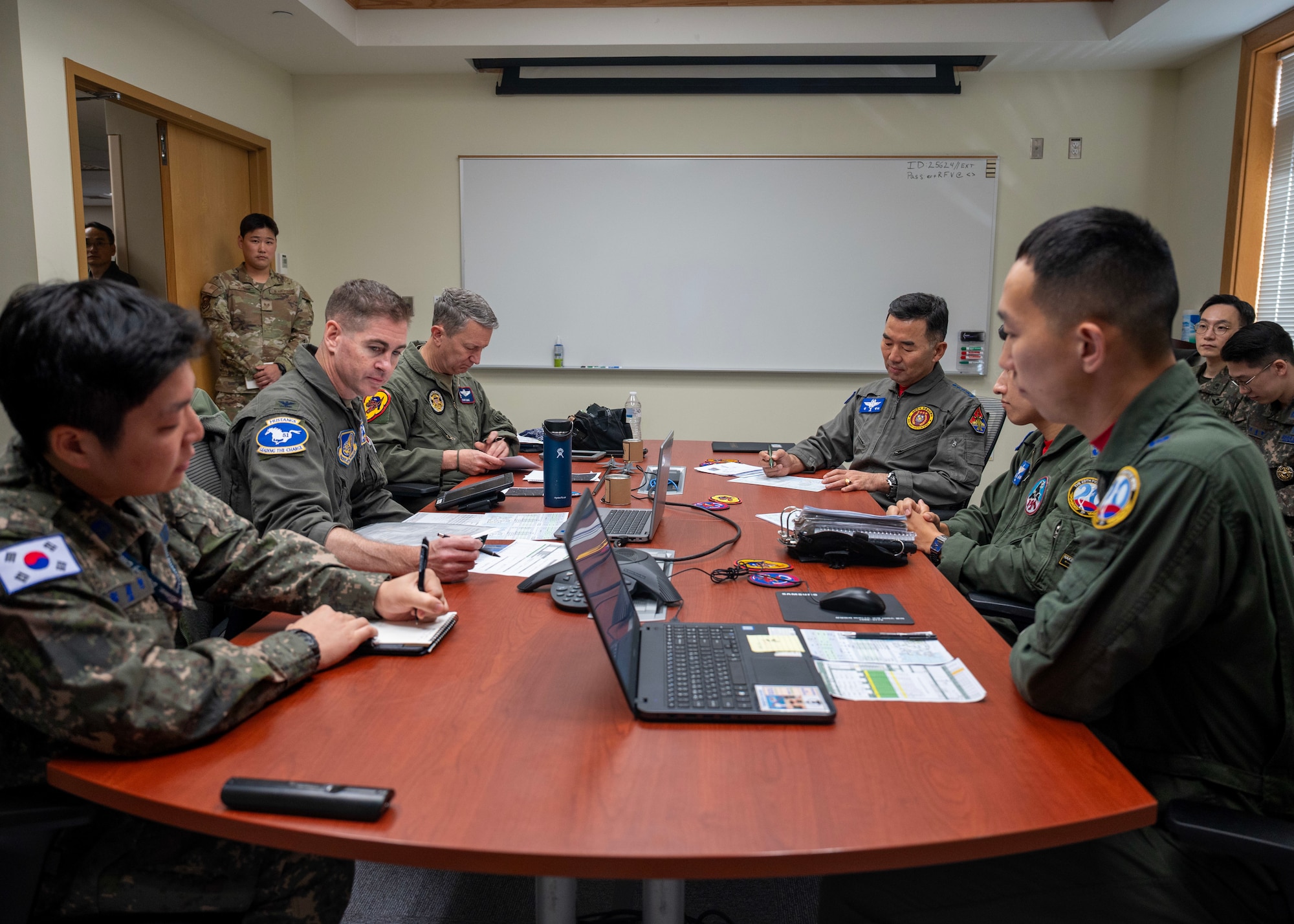 Chairman of the Joint Chiefs of Staff Gen. Dan Caine and the Republic of Korea Chairman of the Joint Chiefs of Staff Gen. Jin Yong Sung participate in a preflight brief before the U.S.-ROK Combined Command Flight at Osan Air Base, ROK, Nov. 3, 2025. The CJCS and other senior leaders arrived to participate in the Security Consultative Meeting and the Military Cooperation Meeting, highlighting the enduring strength of the U.S.-ROK Alliance. (U.S. Air Force photo by Staff Sgt. Sarah Williams)
