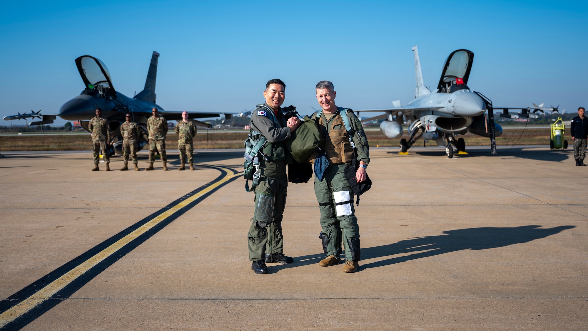 Chairman of the Joint Chiefs of Staff Gen. Dan Caine and the Republic of Korea Chairman of the Joint Chiefs of Staff Gen. Jin Yong Sung pose in front their aircraft before a U.S.-ROK Combined Command Flight at Osan Air Base, ROK, Nov. 3, 2025. The CJCS and other senior leaders arrived to participate in the Security Consultative Meeting and the Military Cooperation Meeting, highlighting the enduring strength of the U.S.-ROK Alliance. (U.S. Air Force photo by Staff Sgt. Sarah Williams)