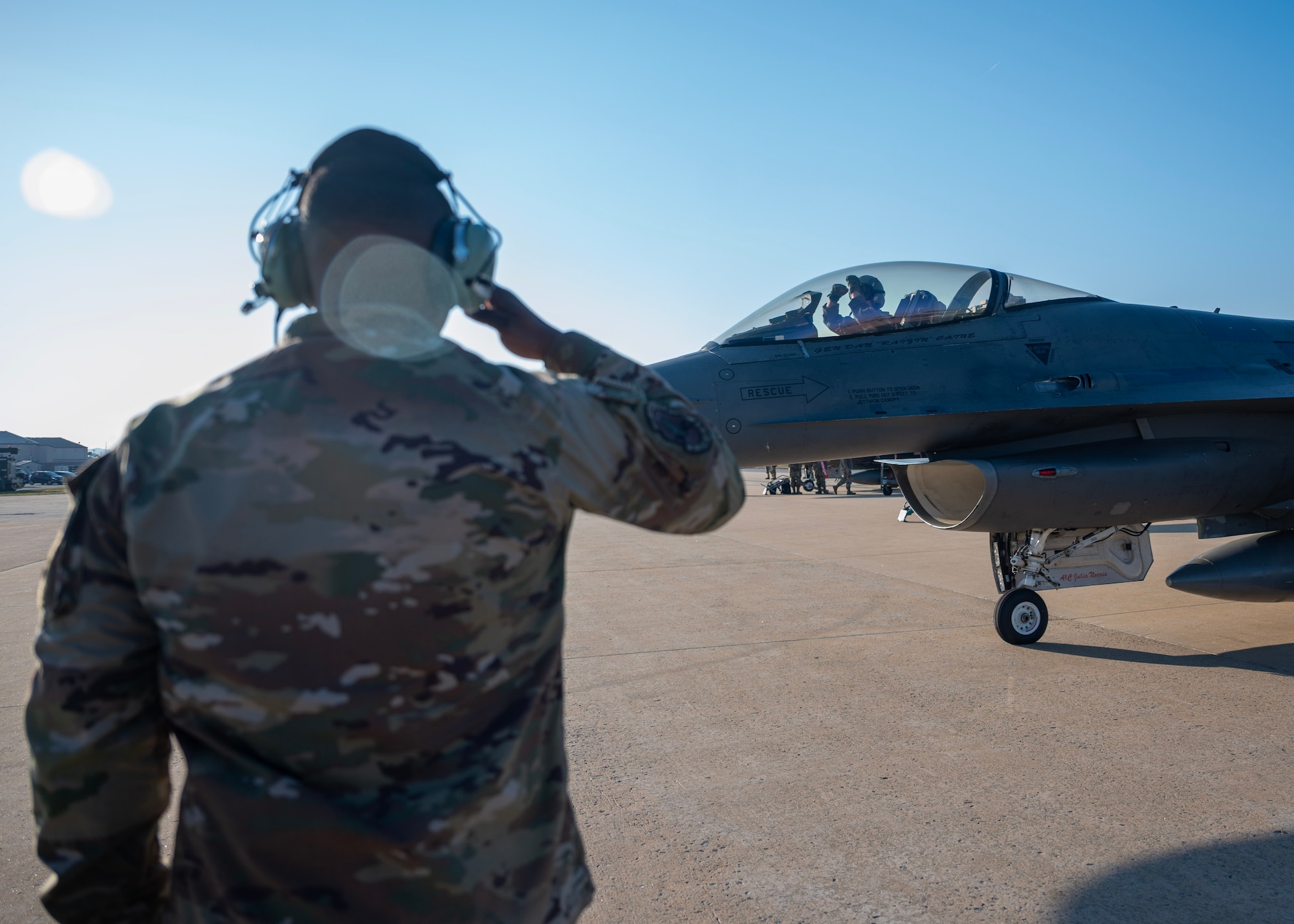 U.S. Air Force Staff Sgt. Carlin Hairston, 36th Fighter Generation Squadron dedicated crew chief, salutes Chairman of the Joint Chiefs of Staff Gen. Dan Caine during the U.S.-Republic of Korea Combined Command Flight at Osan Air Base, ROK, Nov. 3, 2025. The CJCS and other senior leaders arrived to participate in the Security Consultative Meeting and the Military Cooperation Meeting, highlighting the enduring strength of the U.S.-ROK Alliance. (U.S. Air Force photo by Staff Sgt. Sarah Williams)