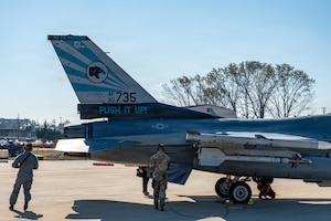 Maintainers conduct postflight inspections on an F-16.