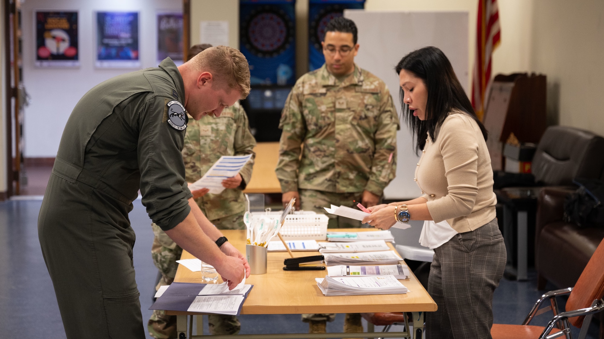 An Airman receives paperwork to inprocess from medical staff.