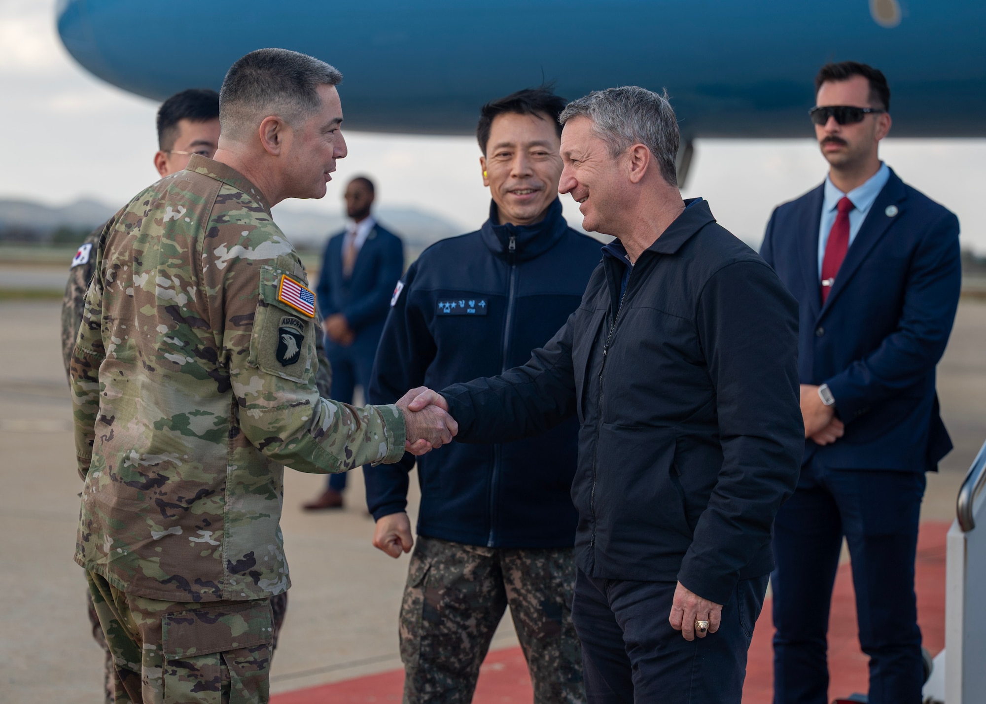 U.S. Army Maj. Gen. Frederick Crist, Deputy Director, C-4, Combined Forces Command/Director of Logistics, U-4, United Nations Command/Director, J-4, United States Forces Korea, Republic of Korea, greets the Chairman of the Joint Chiefs of Staff Gen. Dan Caine at Osan Air Base, ROK, Nov. 2, 2025. The CJCS and other senior leaders arrived to participate in the Security Consultative Meeting and the Military Cooperation Meeting, highlighting the enduring strength of the U.S.-ROK Alliance. (U.S. Air Force photo by Staff Sgt. Sarah Williams)
