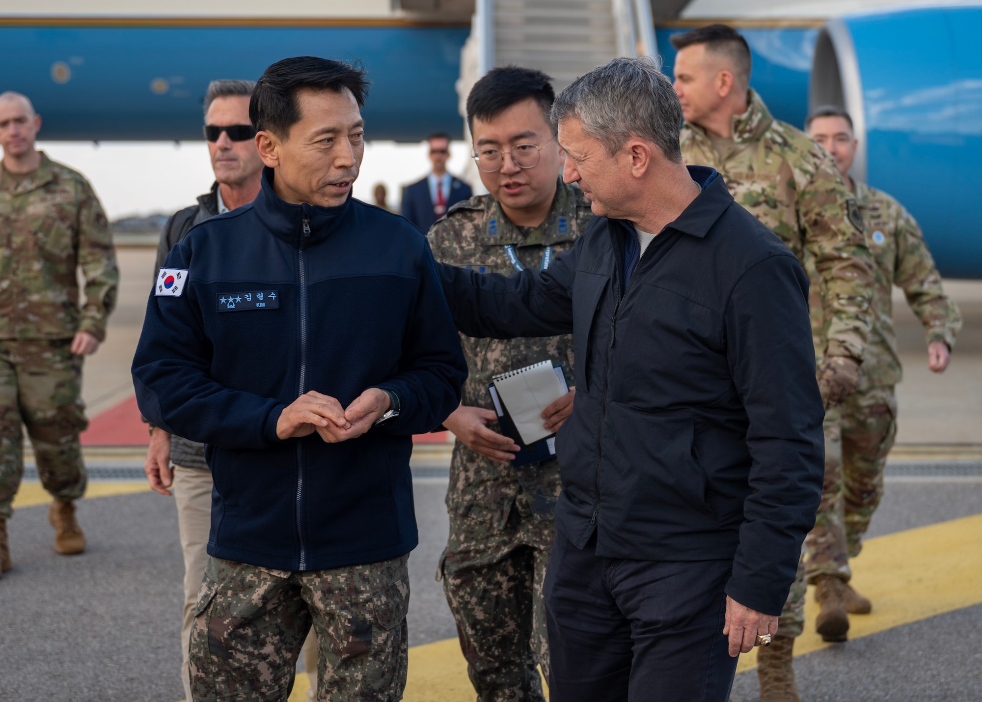 Chairman of the Joint Chiefs of Staff Gen. Dan Caine, right, talks with Republic of Korea Lt. Gen. Kim Hyoung Soo, right, commander of ROKAF Operations Command, at Osan Air Base, ROK, Nov. 2, 2025. The CJCS and other senior leaders arrived to participate in the Security Consultative Meeting and the Military Cooperation Meeting, highlighting the enduring strength of the U.S.-ROK Alliance. (U.S. Air Force photo by Staff Sgt. Sarah Williams)