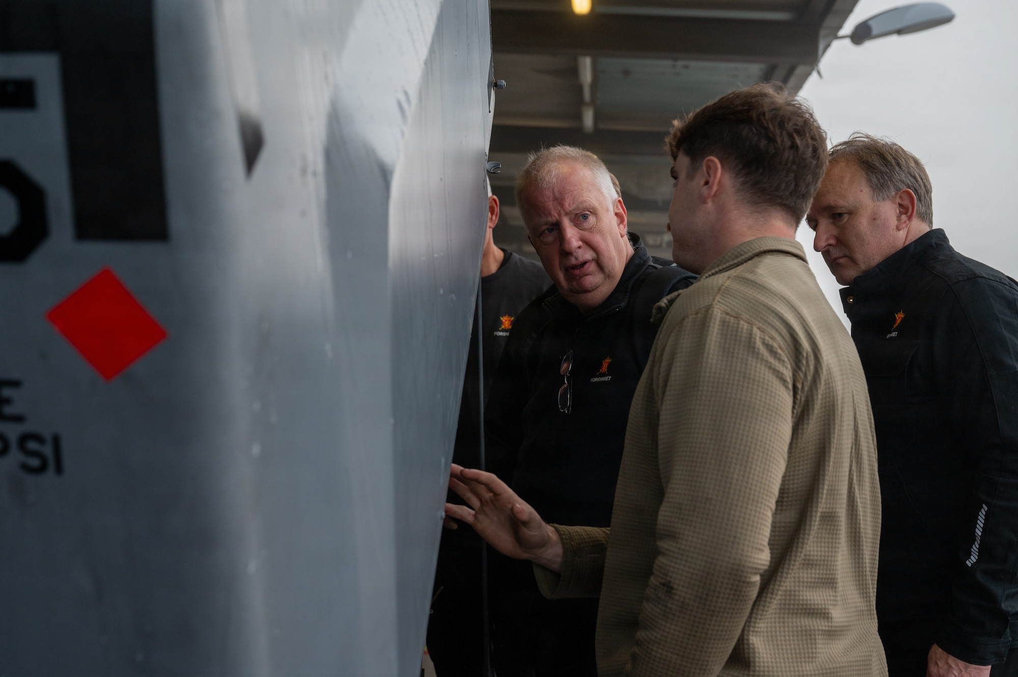 U.S. Air Force Staff Sgt. Zachary Power, 86th Maintenance Squadron noncommissioned officer in charge of dispatch, shows the inner workings of a self-generating nitrogen servicing cart to Royal Norwegian Air Force aerospace ground equipment service members at Ramstein Air Base, Germany, Oct. 8, 2025.