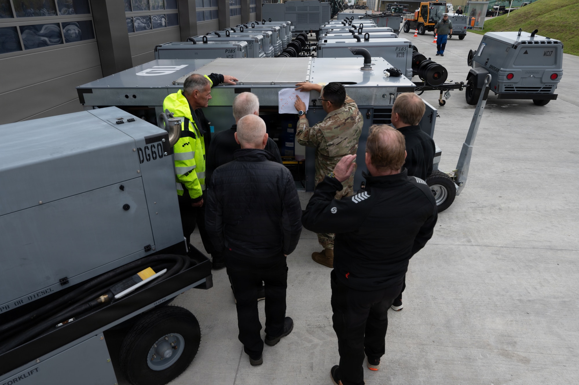 U.S. Air Force Tech. Sgt. Miguel Gil, 86th Material Maintenance Squadron aerospace ground equipment programs manager, shows the blueprints of an ACU-302 Series conditioned air unit to Royal Norwegian Air Force aerospace ground equipment service members during a War Reserve Materiel training event at the Warehouses Service Agency in Sanem, Luxembourg, Oct. 9, 2025.