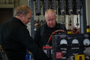 Royal Norwegian Air Force aerospace ground equipment service members look at aerospace ground equipment at Ramstein Air Base, Germany, Oct. 8, 2025.