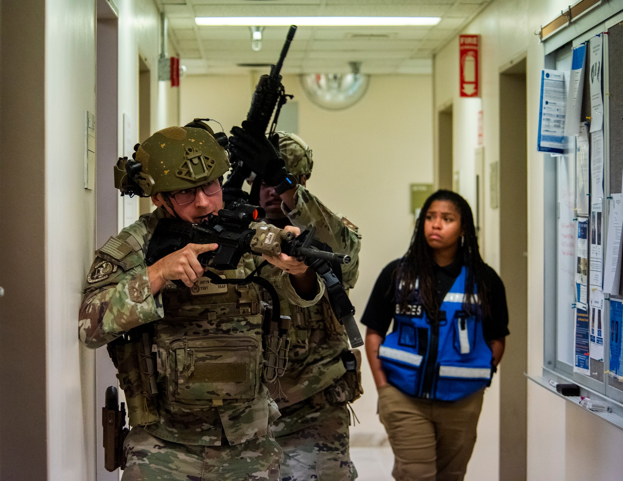 A service member clears a hallway