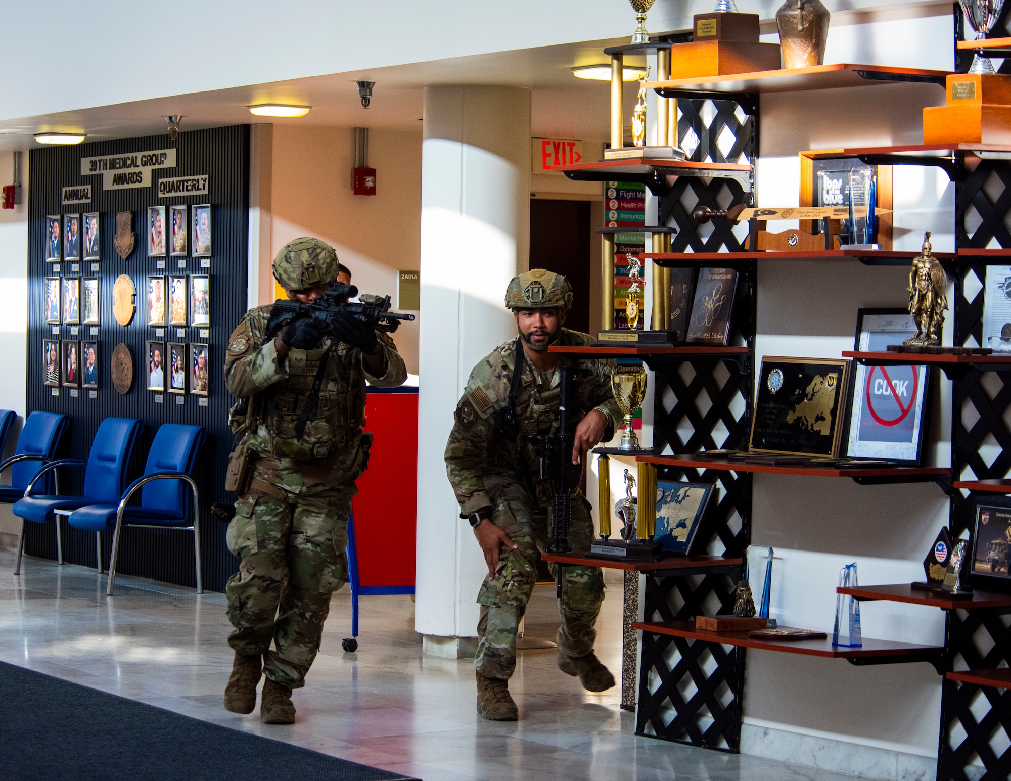 Service members move through a hallway