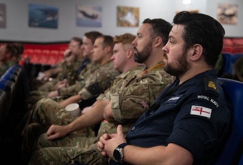 royal navy and royal air force sit in a briefing