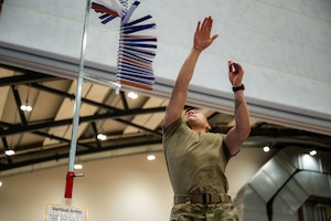 U.S. Air Force Capt. Westley Vicente, 86th Medical Group mental health element chief, does a vertical jump test during the October PT Month Health Fair at Ramstein Air Base, Germany, Oct. 17, 2025.
