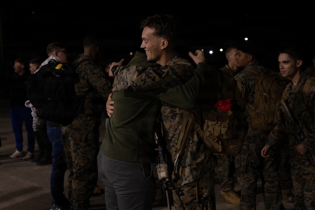 U.S. Marine Corps 1st Lt. Grant Boyes, Left, from Ohio, Hugs 1st Lt. Brady Tynan, from Nevada, both Low Altitude Air Defense Officers with 2nd LAAD, Marine Air Control Group 28, 2nd Marine Aircraft Wing, at Marine Corps Air Station Cherry Point, North Carolina, Nov. 19, 2025. Bravo Battery returned to Cherry Point after a six-month unit deployment to Okinawa, Japan. (U.S. Marine Corps photo by Cpl. Anakin Smith)