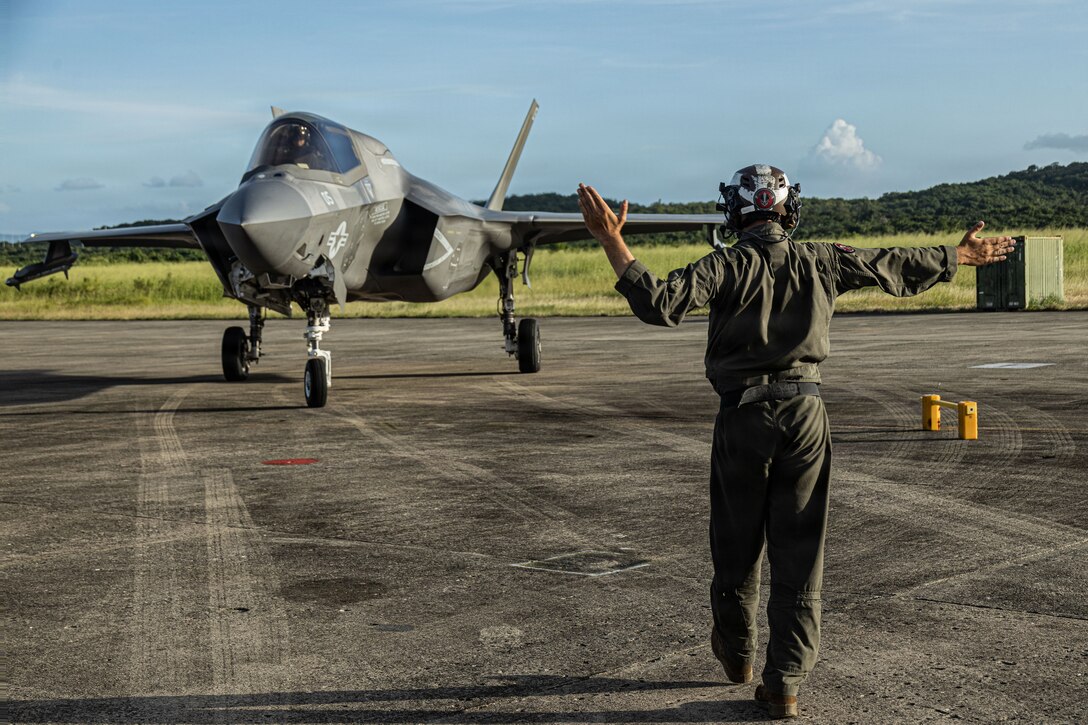 A U.S. Marine with Marine Fighter Attack Squadron (VMFA) 225, U.S. Marine Corps Forces, South, guides a U.S. Marine Corps F-35B Lightning II assigned to VMFA-225 after landing at Jose Aponte de la Torre Airport in Ceiba, Puerto Rico, Nov. 11, 2025. U.S. military forces are deployed to the Caribbean in support of the U.S. Southern Command mission, Department of War-directed operations, and the president’s priorities to disrupt illicit drug trafficking and protect the homeland. (U.S. Marine Corps photo)