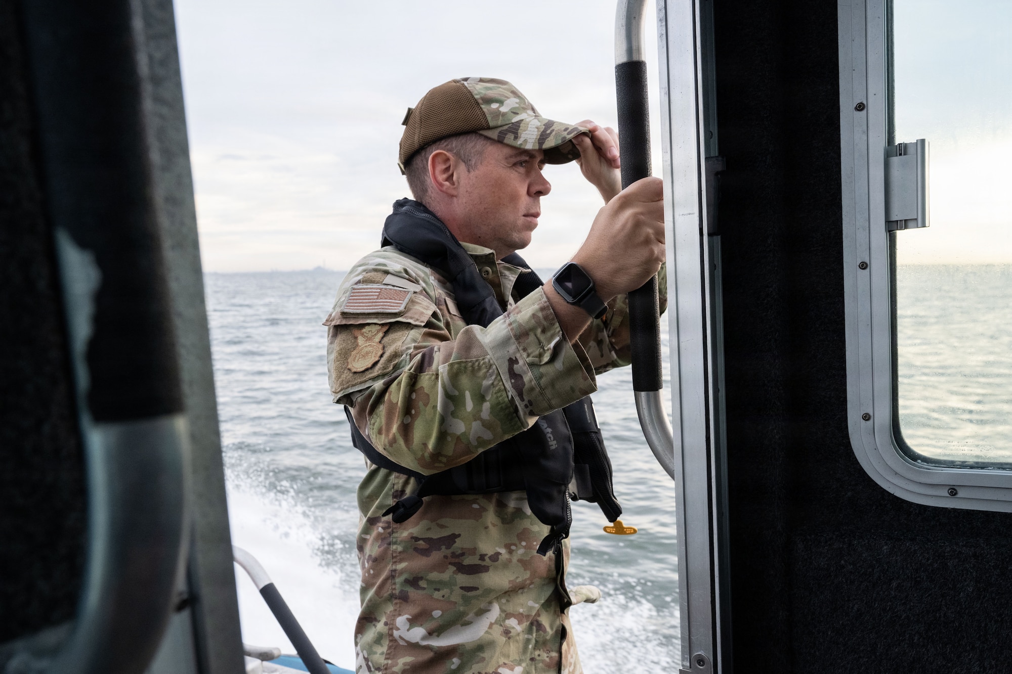 U.S. Air Force Master Sgt. Trevor Brewer,  6th Security Forces Squadron marine patrol section chief, scans the waters at MacDill Air Force Base, Florida, Nov. 6, 2025. The 6th SFS marine patrolmen work to ensure that unauthorized vessels do not enter MacDill’s restricted areas that extend a mile outside of base. (U.S. Air Force photo by Airman Alexis Adams)