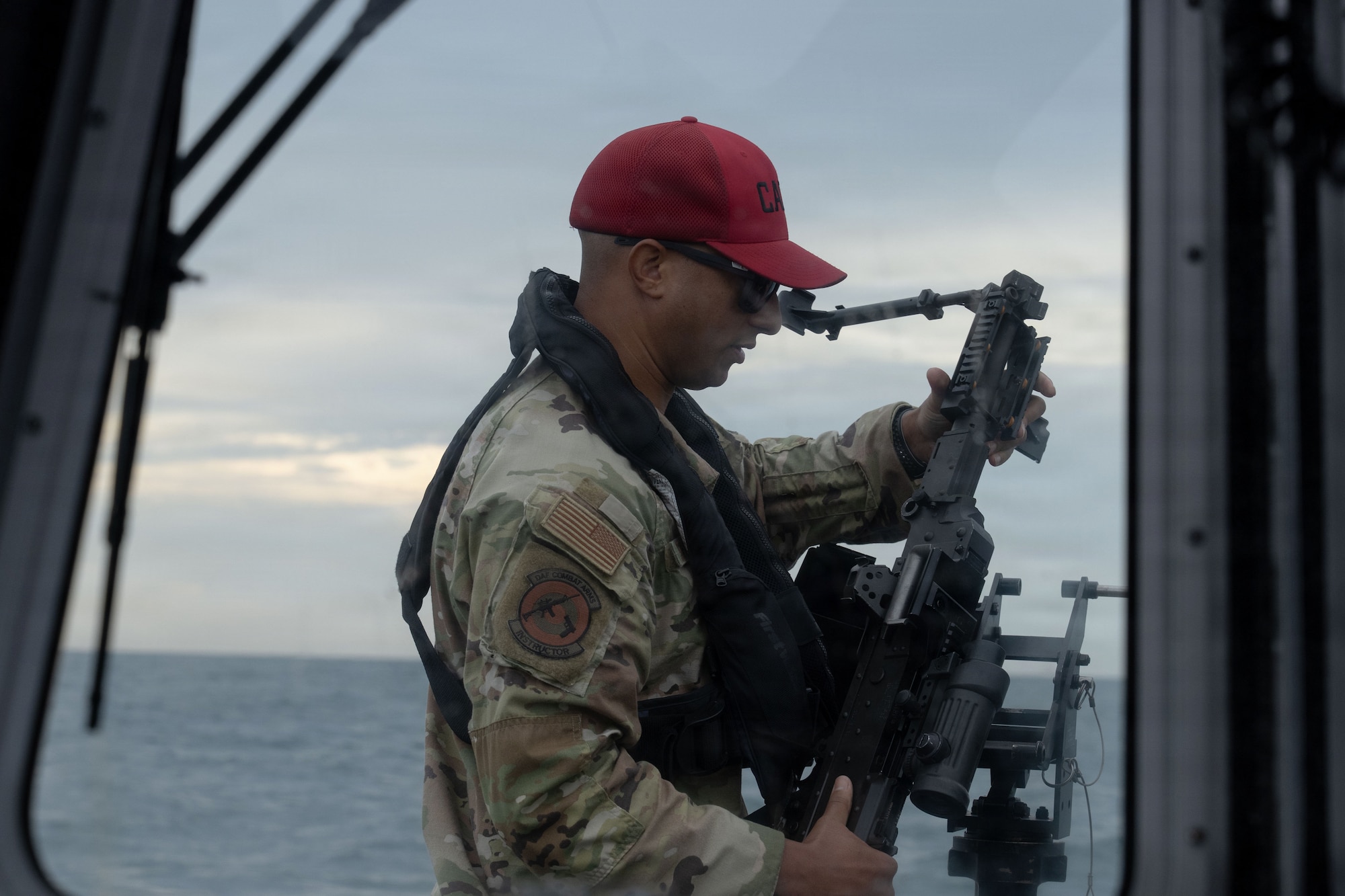 U.S. Air Force Tech. Sgt. Hunter Sterling, 6th Security Forces Squadron combat arms training and maintenance (CATM) section chief, prepares the M240B machine gun for an annual training with the 6th SFS marine patrolmen at MacDill Air Force Base, Florida, Nov. 6, 2025. CATM instructors ensure safety while helping improve a shooter's accuracy and confidence in the weapon. (U.S. Air Force photo by Airman Alexis Adams)