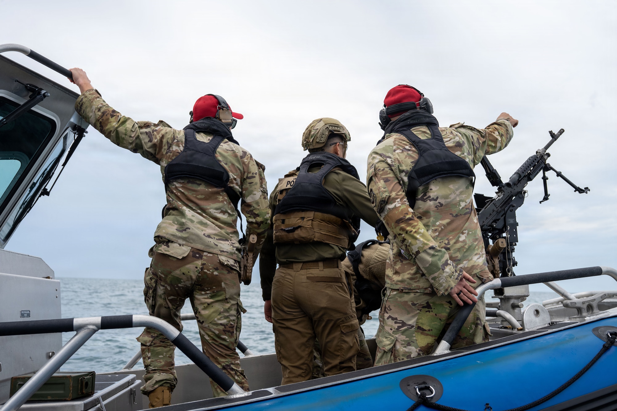 U.S. Air Force marine patrolmen and combat arms training and maintenance (CATM) instructors assigned to the 6th Security Forces Squadron scan the waters to ensure a clear firing range at MacDill Air Force Base, Florida, Nov. 6, 2025. Marine patrolmen are required to be certified in each weapon annually. CATM instructors ensure safety while helping improve a shooter's accuracy and confidence in the weapon. (U.S. Air Force photo by Airman Alexis Adams)