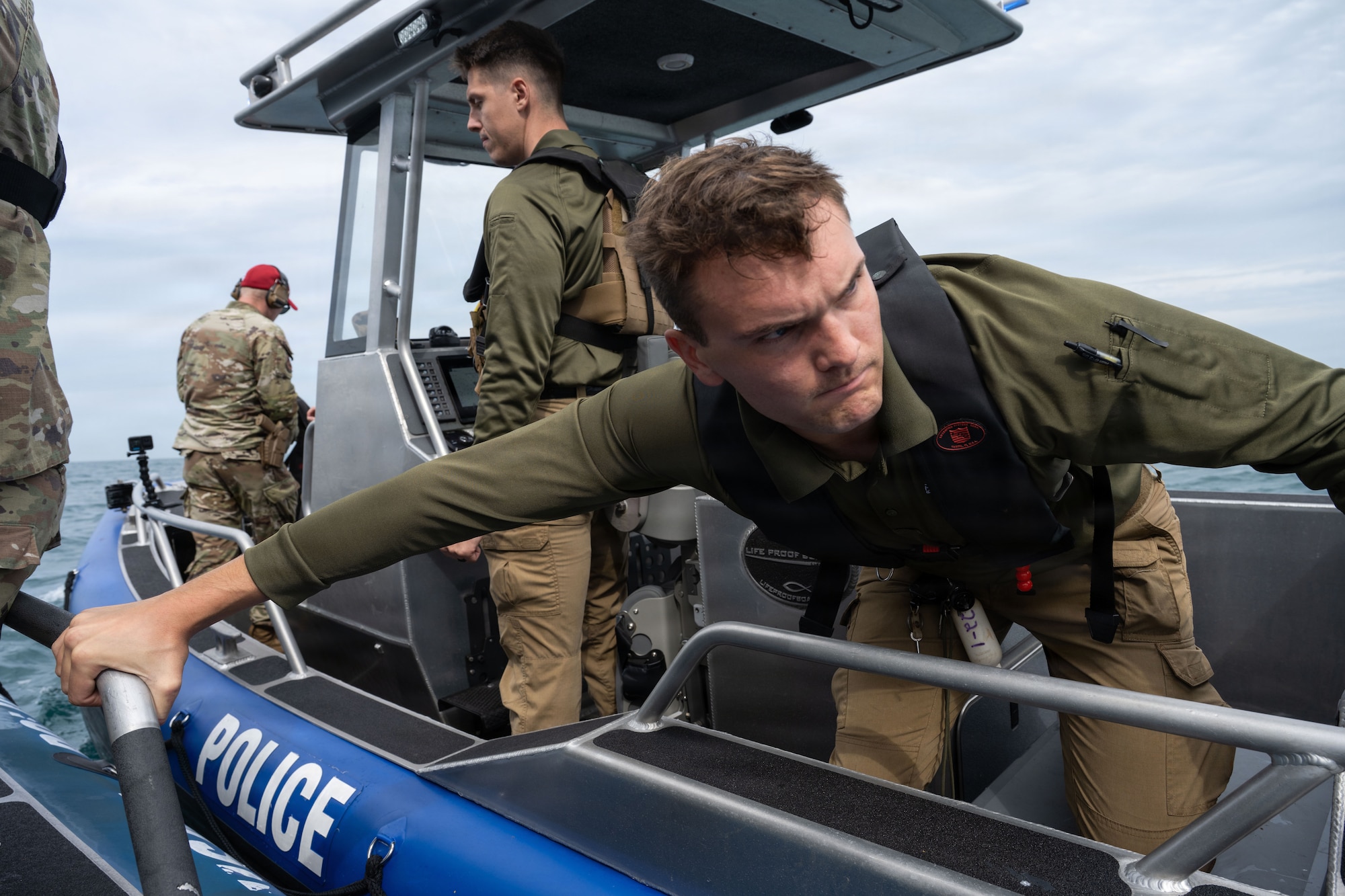 U.S. Air Force Staff Sgt. Travis Knaak,  6th Security Forces Squadron marine patrolman, assists in directing a boat at MacDill Air Force Base, Florida, Nov. 6, 2025. The 6th SFS marine patrolmen work to ensure that unauthorized vessels do not enter MacDill’s restricted areas that extend a mile outside of base. (U.S. Air Force photo by Airman Alexis Adams)