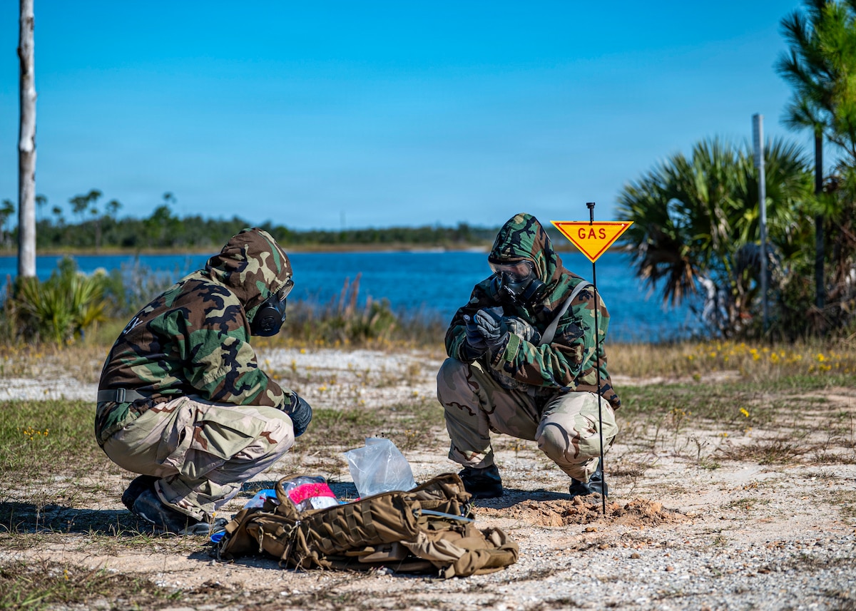 Airmen assigned to the 23rd Combat Air Base Squadron take soil samples during exercise Silver Flag at Tyndall Air Force Base, Fla., Nov. 13, 2025. This is part of the training for chemical, biological, radiological and nuclear detection and evaluation to determine potential contamination to protect personnel in deployed environments. (U.S. Air Force photo by Senior Airman Leonid Soubbotine)