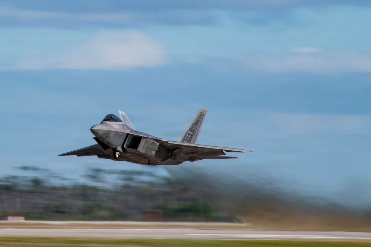 An F-22 Raptor assigned to Joint Base Langley-Eustis takes off during exercise Checkered Flag 26-1 at Tyndall Air Force Base, Fla., Oct. 29, 2025. Checkered Flag and Weapons System Evaluation Program, two large-scale exercises running concurrently, brought together U.S. Air Force, Marine Corps, Navy and the Royal Australian Air Force, as the 122nd Fighter Wing validated its aircraft conversion by demonstrating full mission readiness and the ability to employ live munitions in joint combat training. (U.S. Air National Guard photo by Senior Airman Halley Clark)
