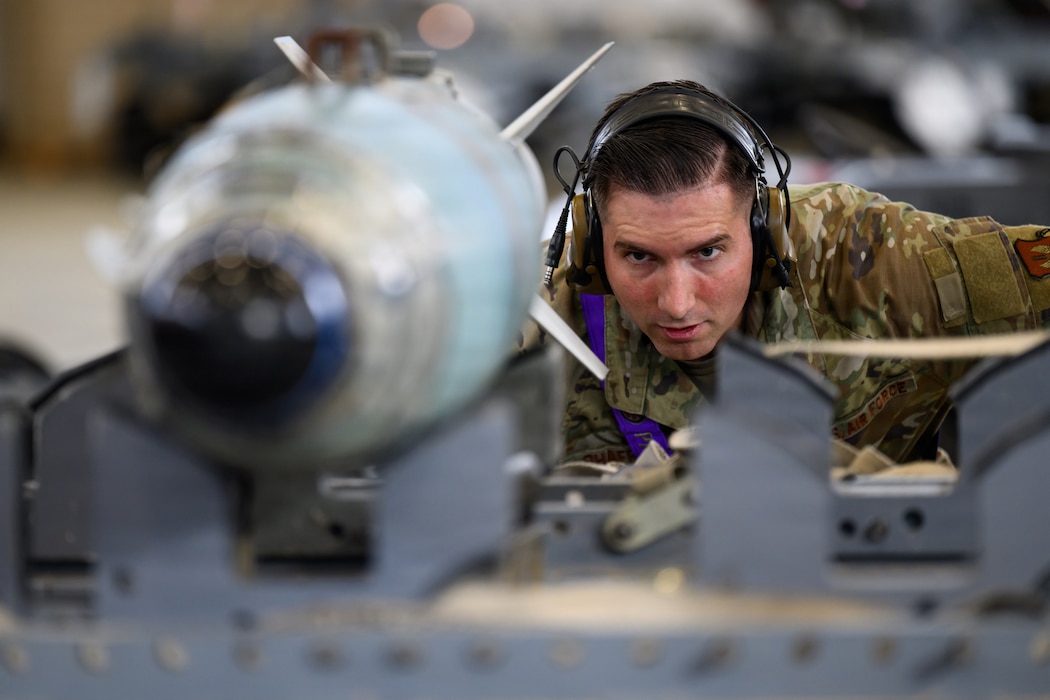 Airman looking at a bomb