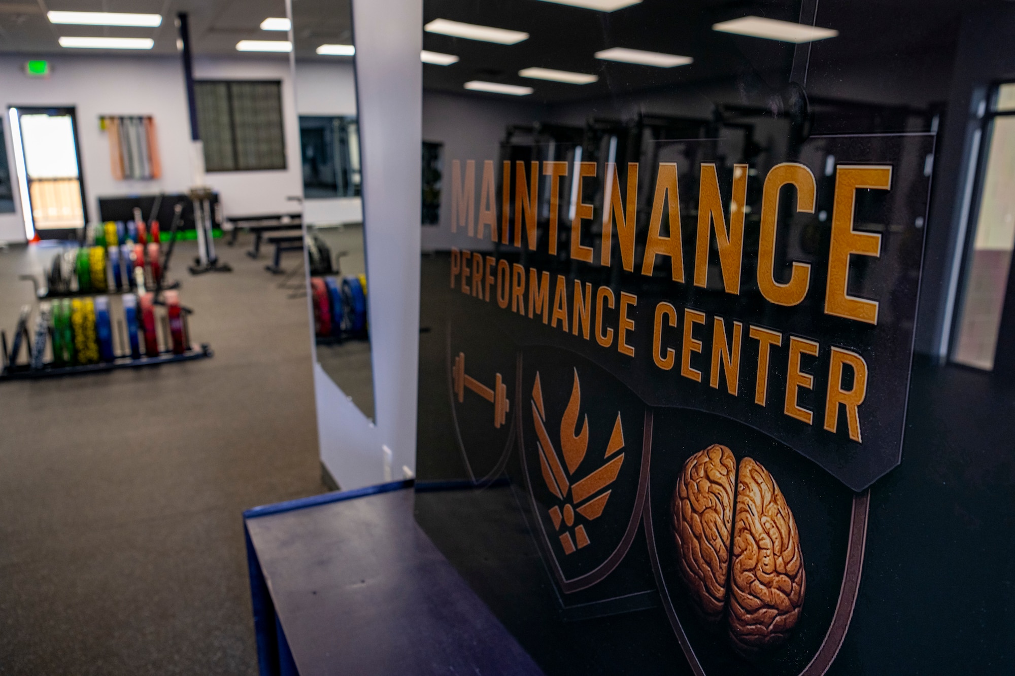 A photo of a sign at the entrance of a gym that reads "Maintenance Performance Center."
