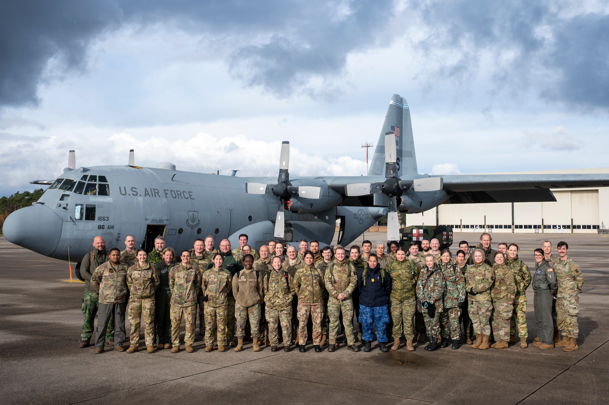NATO Centre of Excellence for Military Medicine Medical Evaluation Course students and instructors, 86th Aeromedical Squadron Airmen, 16th Sustainment Brigade Soldiers and Landstuhl Regional Medical Center Airmen, pose for a group photo after a mock medical evaluation at Ramstein Air Base, Germany, Nov. 20, 2025.