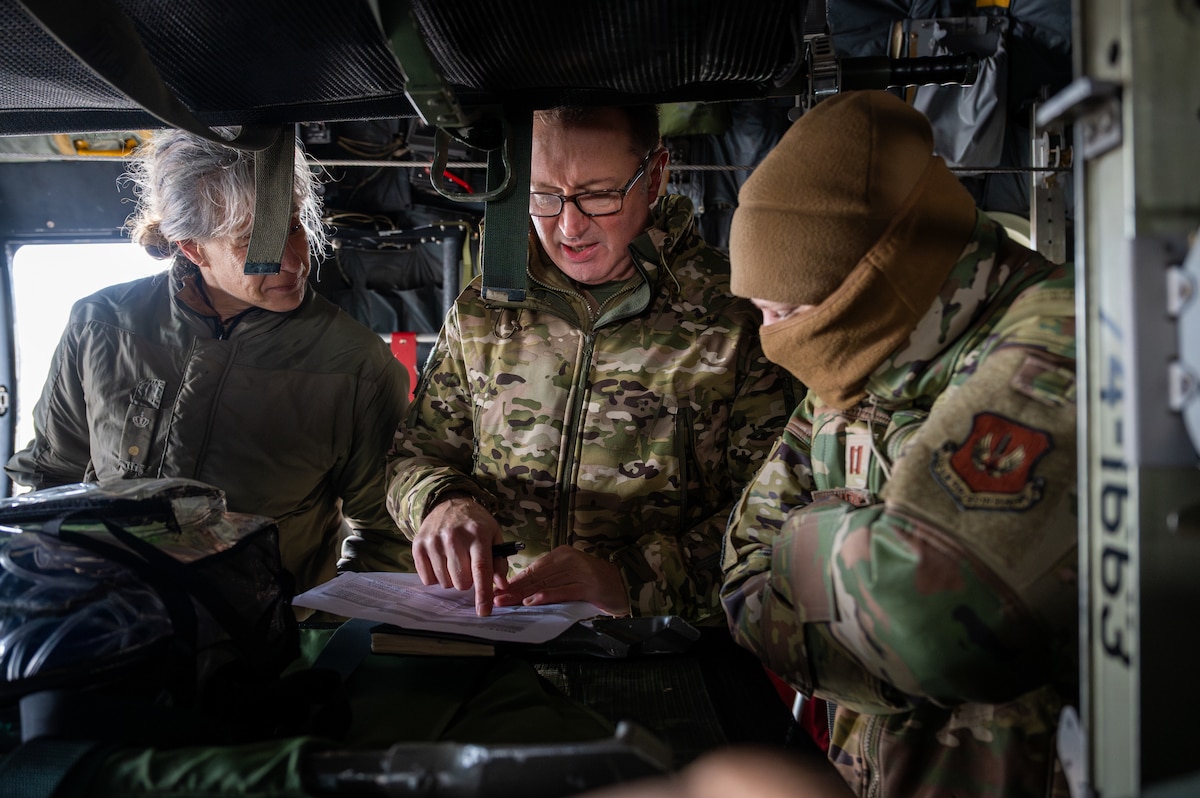 Three NATO Medical Evaluation Course students discuss their observations during a mock evaluation at Ramstein Air Base, Germany, Nov. 20, 2025.