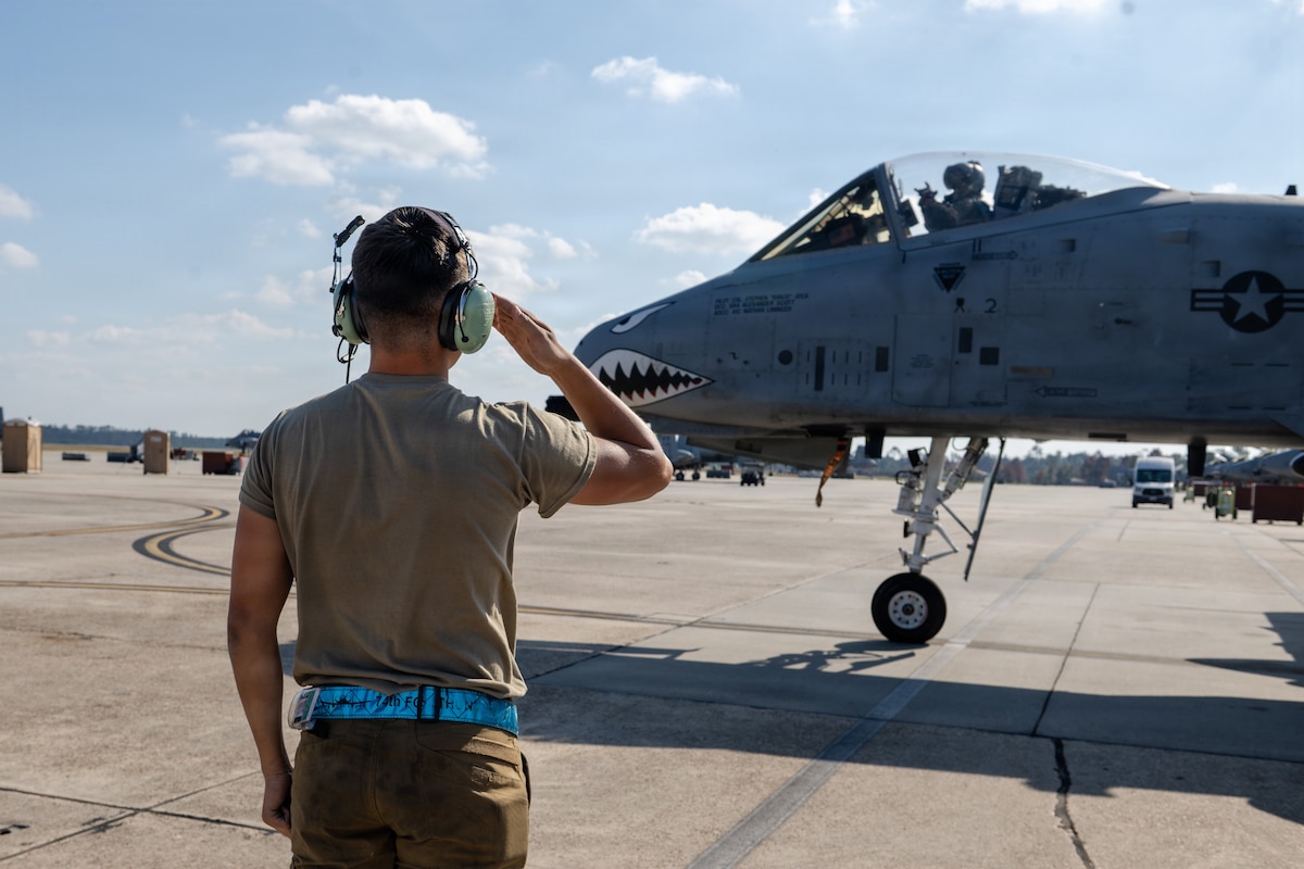 A U.S. Air Force crew chief salutes a pilot in an A-10C Thunderbolt II during exercise Mosaic Tiger 26-1 at Moody Air Force Base Georgia, Nov. 20, 2025. The exercise placed aircrews in simulated contested and degraded environments, challenging the 74th MGFE to practice decentralized execution and maintain sortie generation with limited communication.  (U.S. Air Force photo by Senior Airman Iain Stanley)