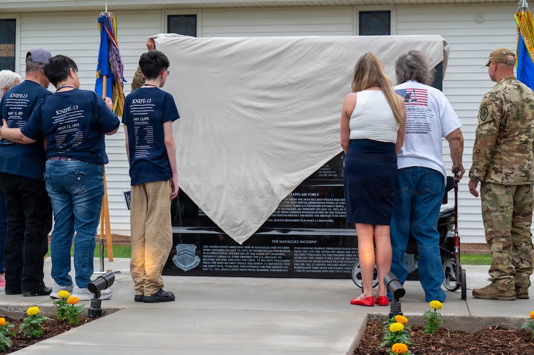 Family members of the fallen members of Knife 13 join Airmen from the 56th Fighter Wing in unveiling the Knife 13 Memorial Wall, Oct. 10, 2025, at Luke Air Force Base, Arizona. The new monument serves as a lasting tribute to the 18 security policemen and five aircrew members who perished when their CH-53C Sea Stallion crashed on May 13, 1975. The polished granite monument bears the names of the fallen and reflects the enduring bond between past and present generations of Airmen.