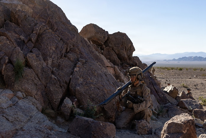 U.S. Marine Corps Lance Cpl. Carter Johnson, a combat engineer with Charlie company, 1st Combat Engineer Battalion, 1st Marine Division, holds an expedient Bangalore torpedo during Range 400 at Marine Corps Air-Ground Combat Center Twentynine Palms, California, Oct. 25, 2025. Range 400 is a dynamic live-fire range that allows companies the ability to rehearse tactics and procedures for attacking fortified areas. Johnson is a native of Iowa. (U.S. Marine Corps photo by Cpl. Earik Barton)