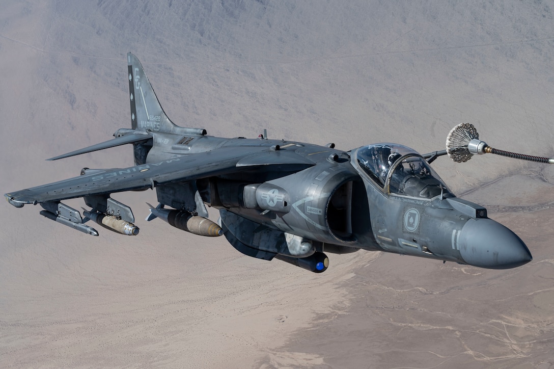 A U.S. Marine AV-8B Harrier assigned to Marine Attack Squadron 231 receives fuel from an Air Force MC-130J Commando II Air Force Special Operations Command during Emerald Warrior 25.1 in Arizona, Feb. 6, 2025.  Emerald Warrior is the premier operational exercise for Air Force Special Operations Command, training combat-ready forces to respond to various threats across the spectrum of conflict. (U.S. Air Force photo by Staff Sergeant Tyler McQuiston)