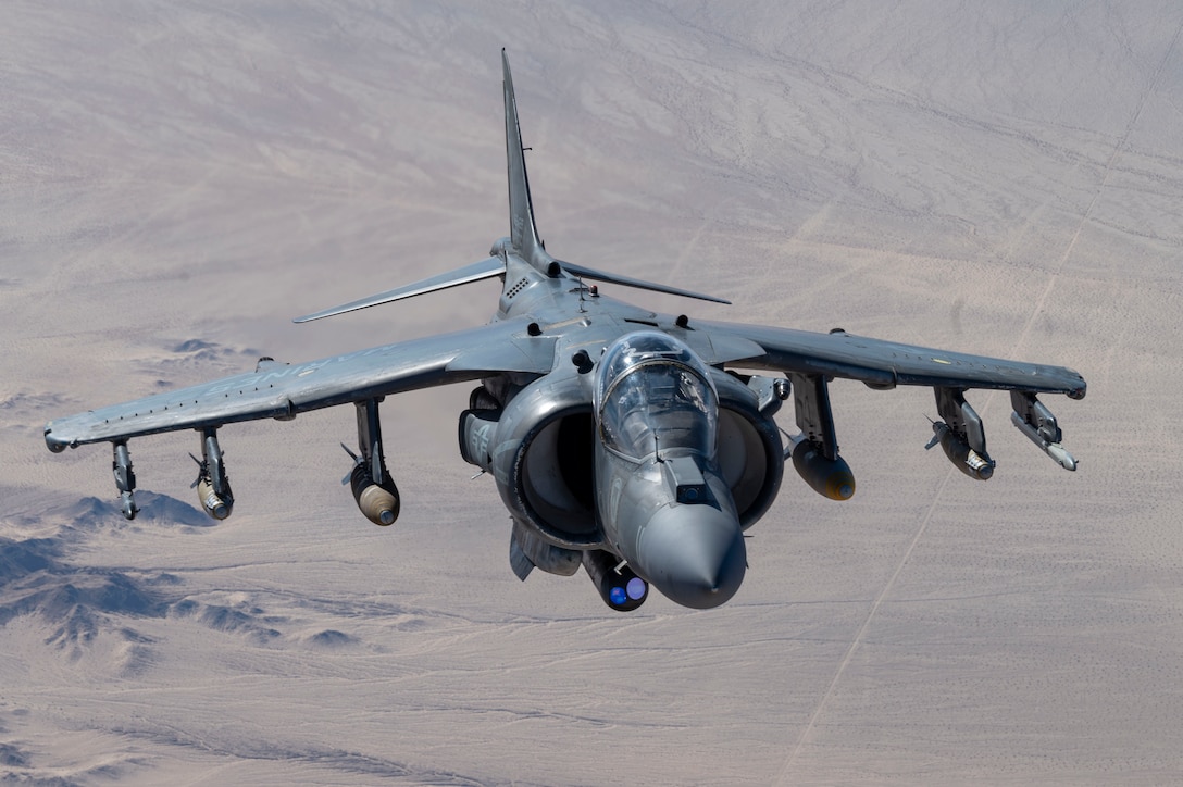 A U.S. Marine AV-8B Harrier assigned to Marine attack squadron 231 moves away from a Air Force MC-130J Commando II Air Force Special Operations Command after refueling during Emerald Warrior 25.1 in Arizona, Feb. 6, 2025. Supported by U.S.Emerald Warrior is the premier operational exercise for Air Force Special Operations Command, training combat ready forces to respond to various threats across the spectrum of conflict. (U.S. Air Force photo by Staff Sergeant Tyler McQuiston)