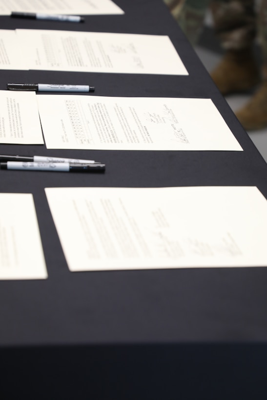 The signed commitments set on the table during the Recruiting and Retention Battalion’s signing of mission commitments for FY26 at Joint Force Headquarters, Sept. 30, 2025