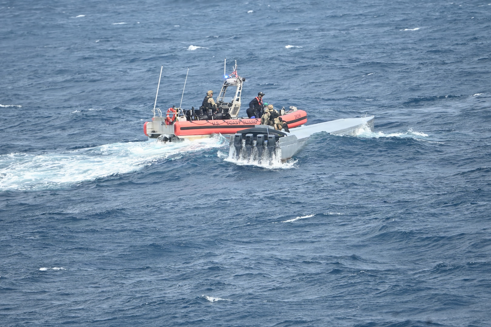 A Coast Guard law enforcement team assigned to Coast Guard Cutter Tampa (WMEC 902) boards a low-profile vessel suspected of trafficking illicit narcotics about 270 nautical miles southeast of the Galapagos Islands in the Pacific Ocean on Oct. 8, 2025. The interdiction was part of counterdrug operations in the Eastern Pacific. (U.S. Coast Guard photo by Petty Officer 2nd Class Kayla Harrison)