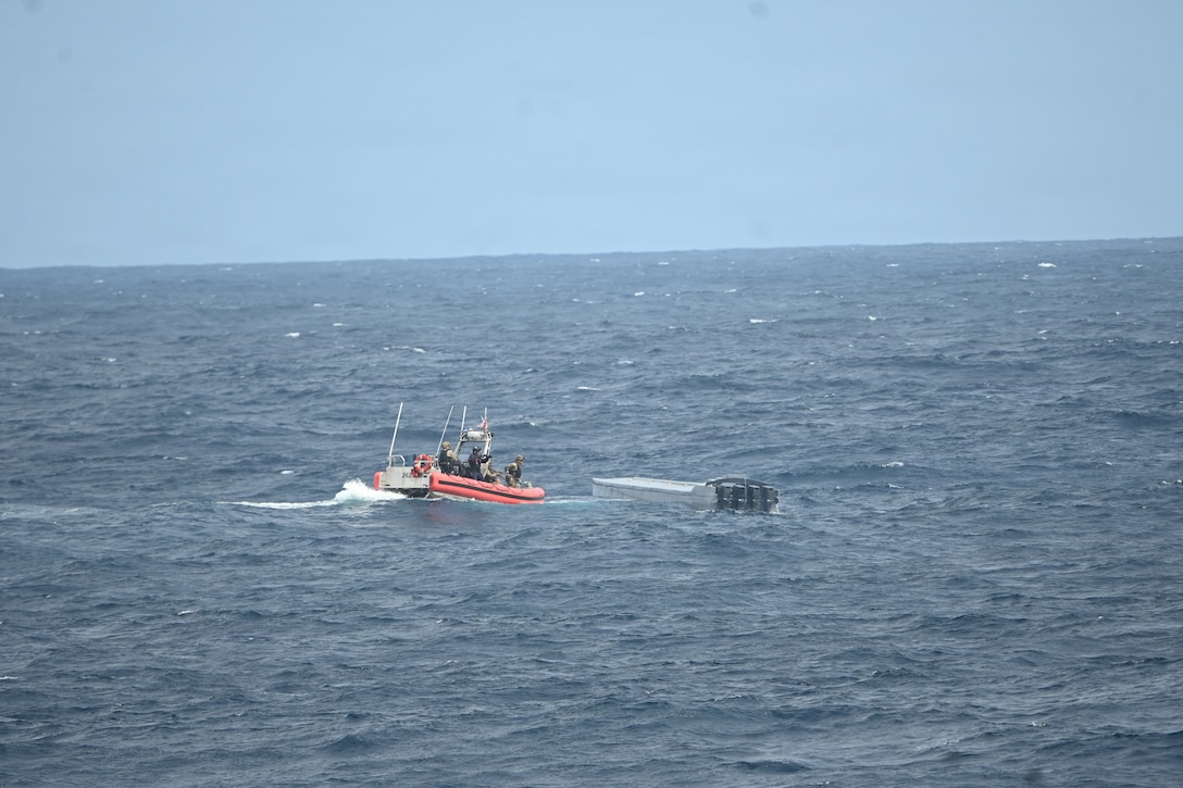 A Coast Guard law enforcement team boards a low-profile vessel suspected of trafficking illicit narcotics about 270 nautical miles southeast of the Galapagos Islands in the Pacific Ocean on Oct. 8, 2025. The interdiction was part of counterdrug operations in the Eastern Pacific. (U.S. Coast Guard photo by Petty Officer 2nd Class Kayla Harrison)