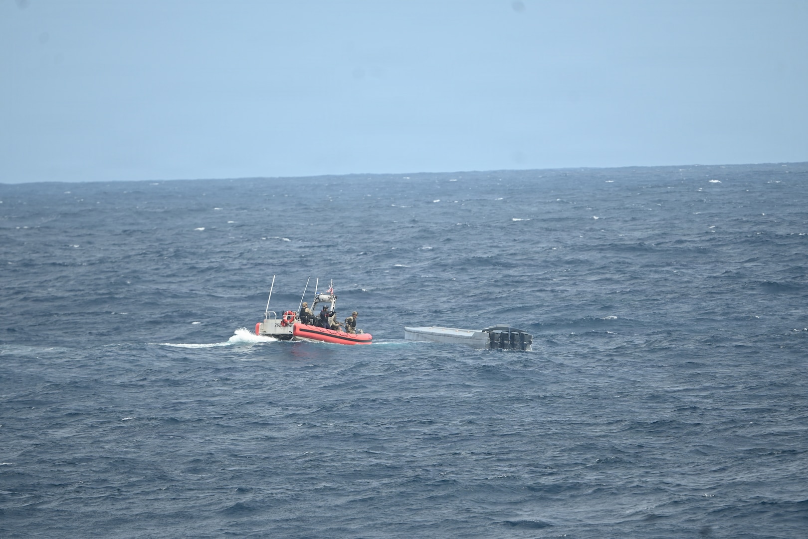 A Coast Guard law enforcement team boards a low-profile vessel suspected of trafficking illicit narcotics about 270 nautical miles southeast of the Galapagos Islands in the Pacific Ocean on Oct. 8, 2025. The interdiction was part of counterdrug operations in the Eastern Pacific. (U.S. Coast Guard photo by Petty Officer 2nd Class Kayla Harrison)