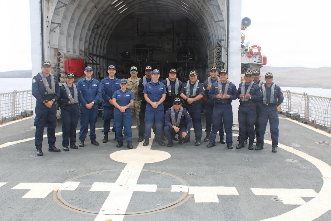 Members of the Ecuadorian coast guard  pose with the command and crew of the Coast Guard Cutter Tampa (WMEC 902) on the cutter's flight deck while anchored in San Cristobal, Ecuador, Galapagos Islands, Oct. 11, 2025. Tampa’s crew deployed in support of counterdrug operations in the Eastern Pacific. (U.S. Coast Guard photo by Ensign Isaac Magee)