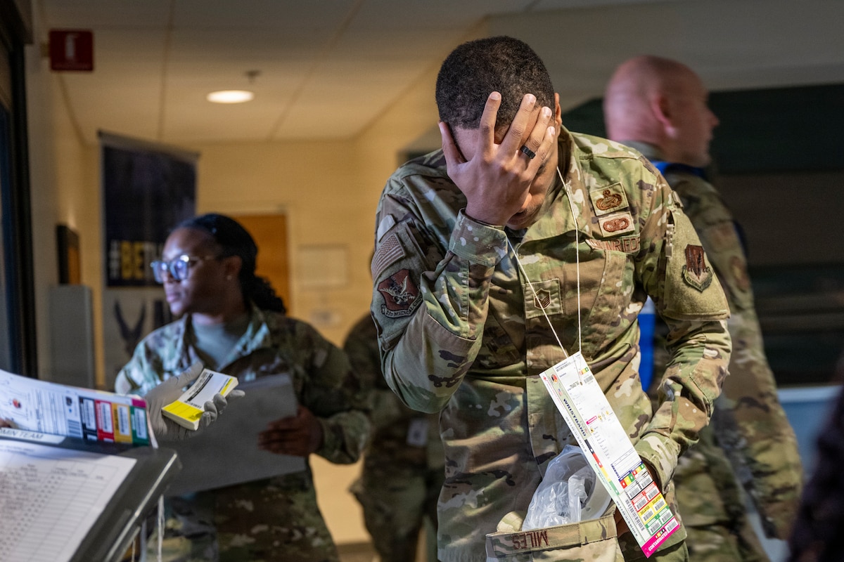 A U.S. Air Force Airman acts as a distressed patient during a public health emergency exercise at Moody Air Force Base, Georgia, Nov. 19, 2025. The exercise challenged Airmen to operate as a cohesive, multi-capable force, strengthening the trust, communication and adaptability needed to ensure medical readiness. (U.S. Air Force photo by Airman Breanna Lewis)