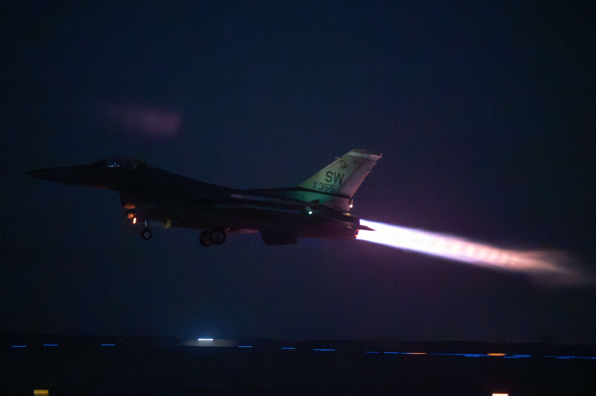 An F-16 takes off at night