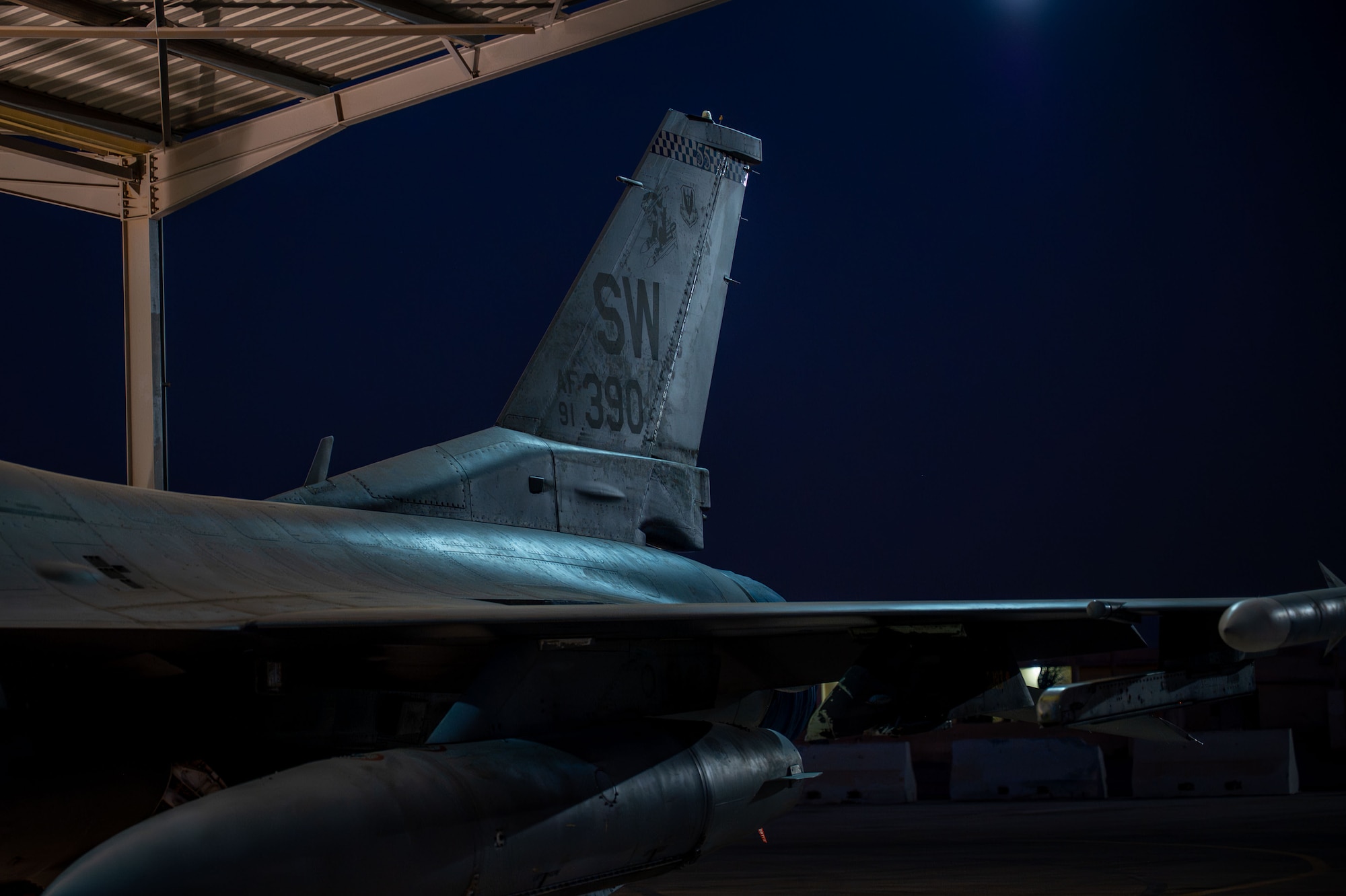 The tail flash of an F-16 at night