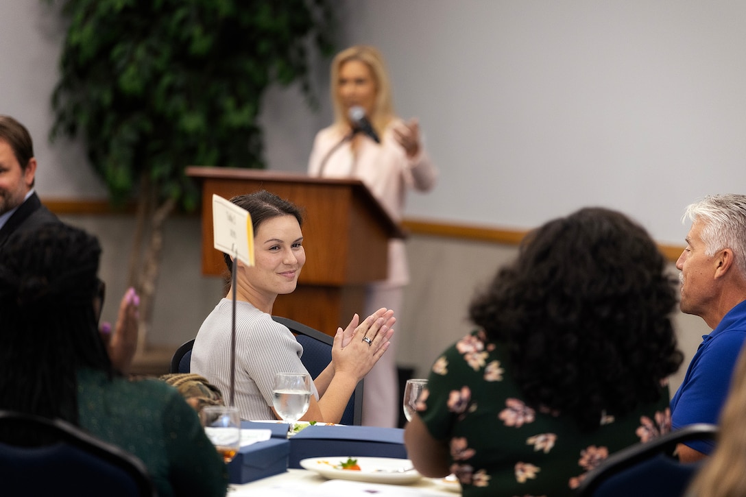 Taylor Comstock, environmental protection specialist at Marine Corps Support Facility Blount Island, applauds as Jacksonville Mayor Donna Deegan recognizes local environmental efforts during the Environmental Achievement Awards luncheon Nov. 21, 2025, at the University of North Florida’s Adam W. Herbert University Center in Jacksonville, Florida. (Official Marine Corps photo by Dustin Senger)