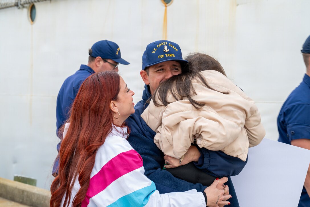 A Coast Guard crewmember’s family greets him as Coast Guard Cutter Tampa (WMEC 902) returns to homeport in Portsmouth, Virginia, on Nov. 21, 2025. Tampa’s crew deployed in support of counterdrug operations in the Eastern Pacific. (U.S. Coast Guard photo by Petty Officer 3rd Class Mason Svitenko)
