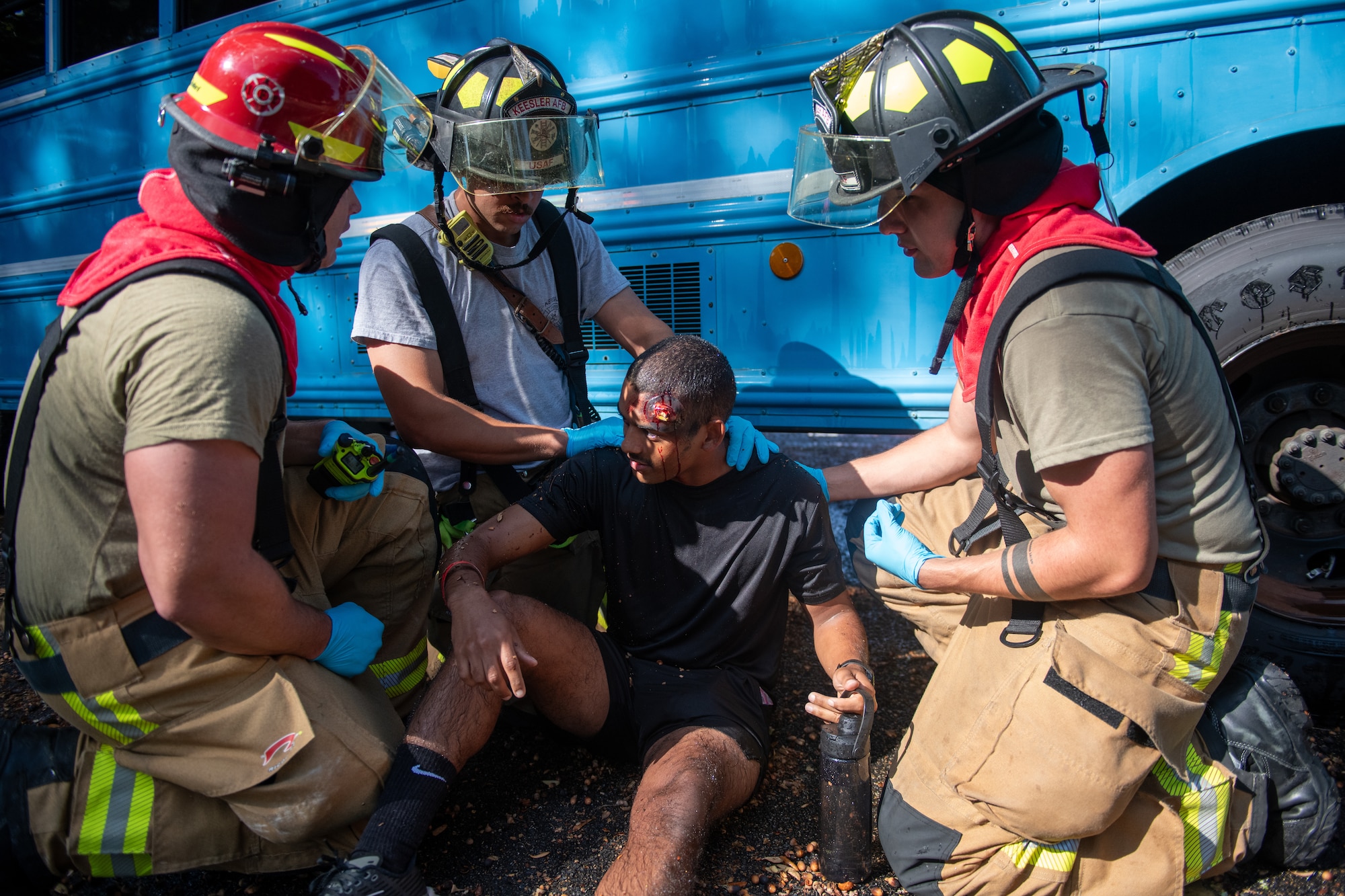 A group of firefighters provide medical care to a patient