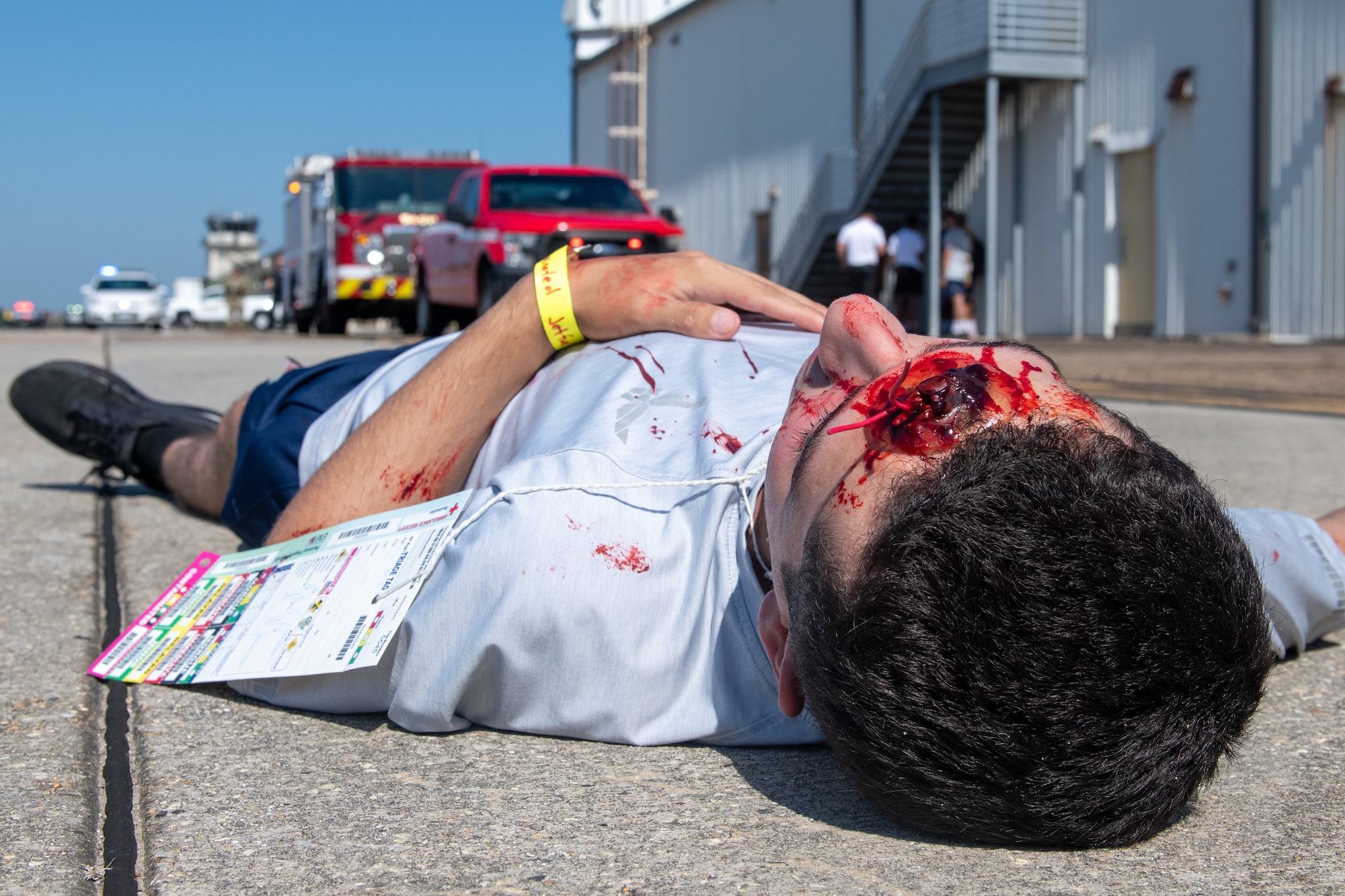 A man in moulage lays on the ground
