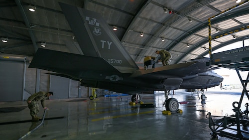 Airmen perform inspection on a jet