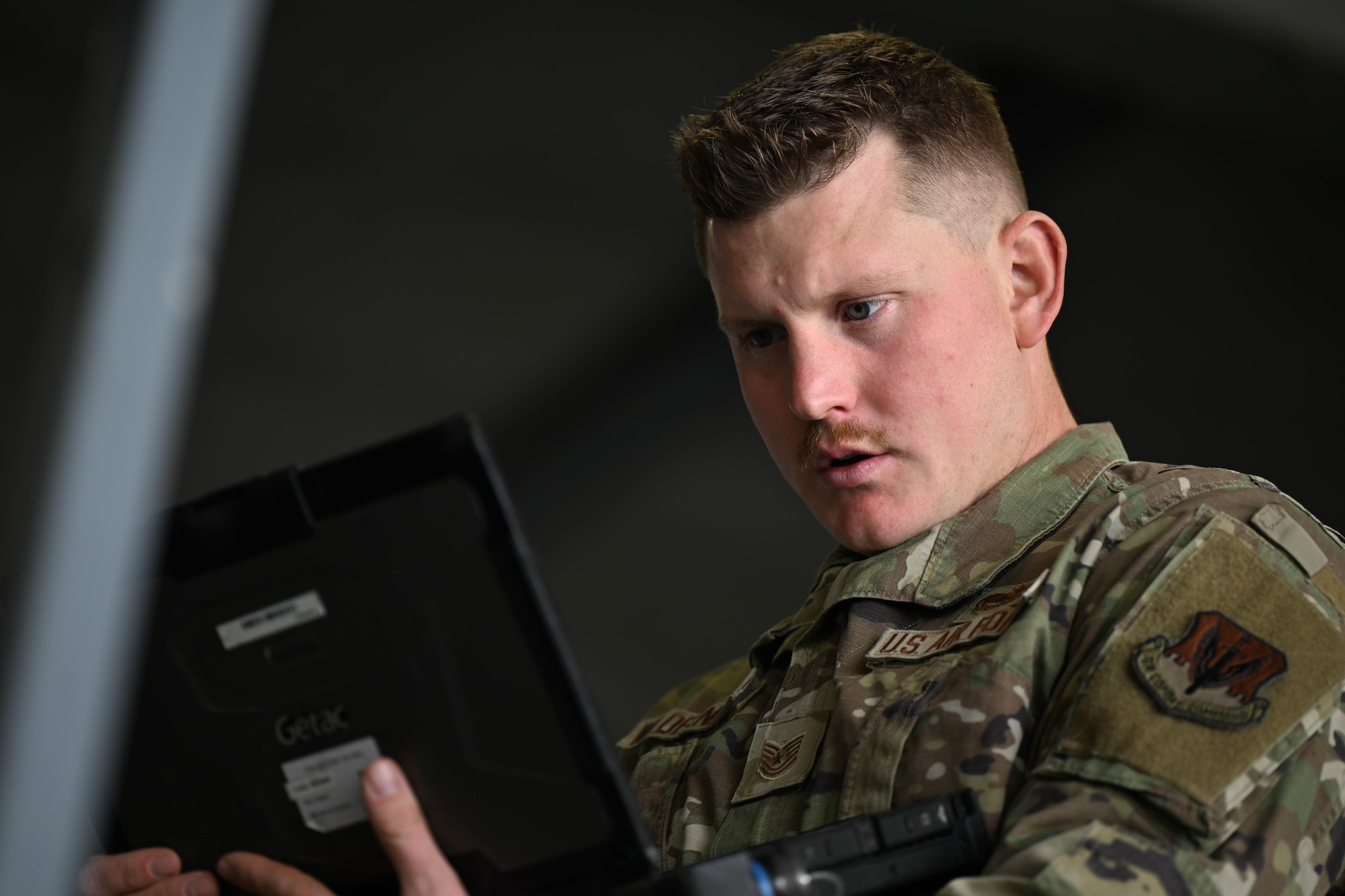 Airmen looks at laptop