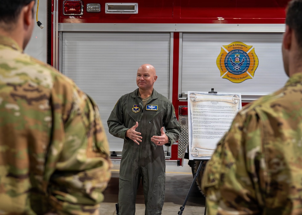 U.S. Air Force Brig. Gen. David Berkland, 56th Fighter Wing commander, speaks to Airmen during a briefing held inside the fire station, Oct. 6, 2025, at Luke Air Force Base, Arizona. The discussion took place as part of Fire Prevention Week activities. Leaders emphasized safety, readiness, and accountability in emergency response situations.