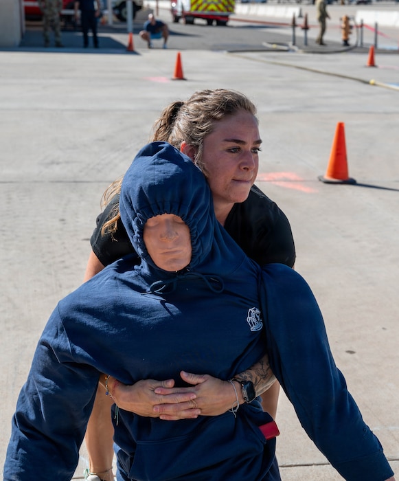 Jaimie Lafler, 56th Medical Group strength and conditioning specialist, hauls a rescue dummy across the course during a firefighter challenge Oct. 7, 2025, at Luke Air Force Base, Arizona. The timed event simulated victim extraction under pressure. The firefighter challenge emphasized real-world readiness through hands-on competition.