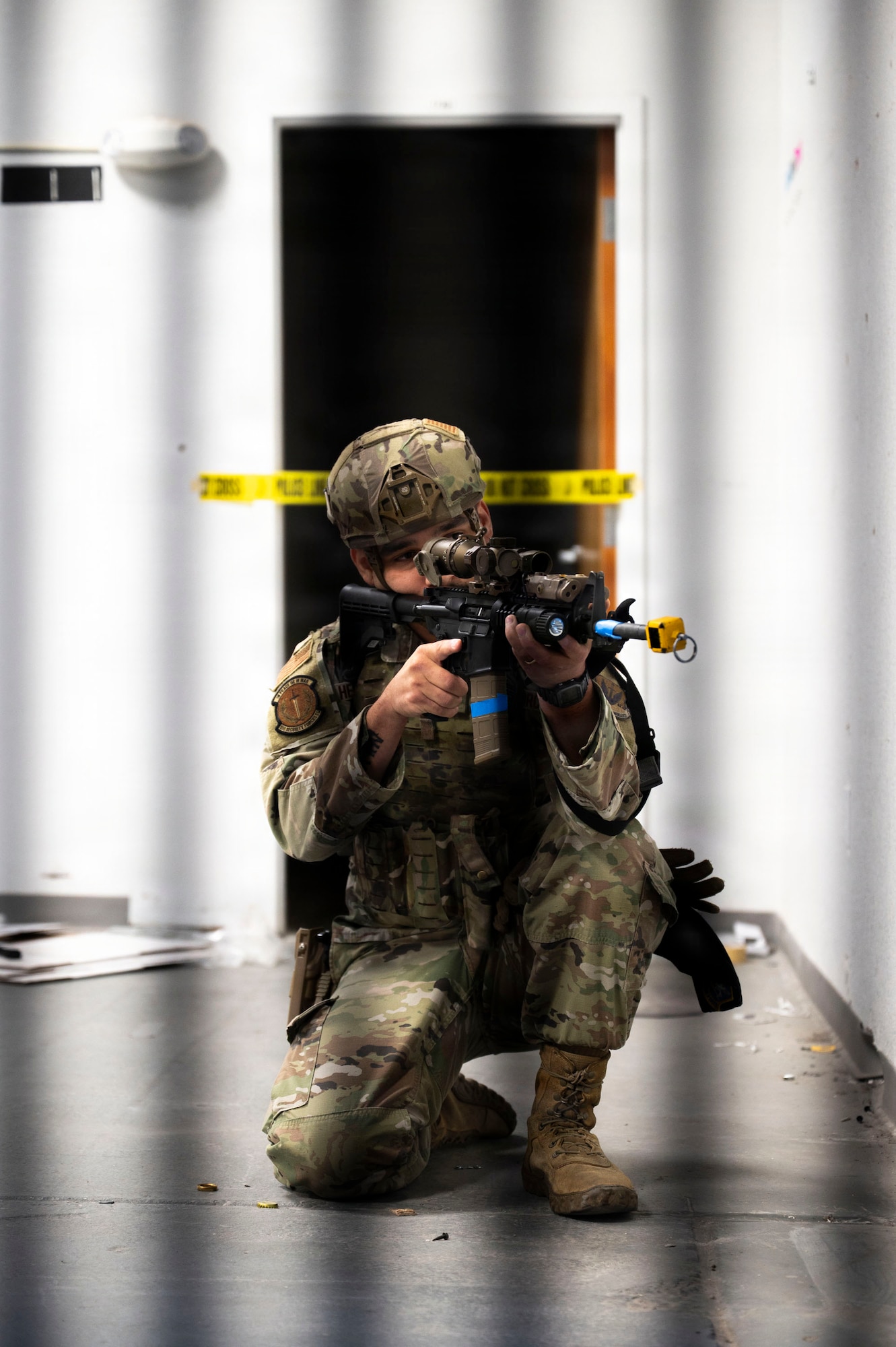 A U.S. Air Force Airman assigned to the 355th Security Forces Squadron stands watch during an active shooter exercise as a part of Mosaic Lightning 26-1 at Davis-Monthan Air Force Base, Arizona, Nov. 13, 2025. The Airmen were required to strategically plan how to neutralize the shooters and move simulated casualties to safety. (U.S. Air Force photo by Airman 1st Class Samantha Melecio)