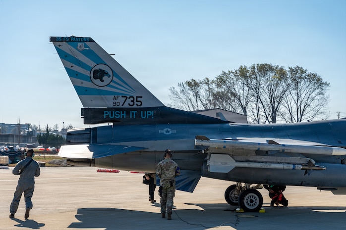 Maintainers conduct postflight inspections on an F-16.